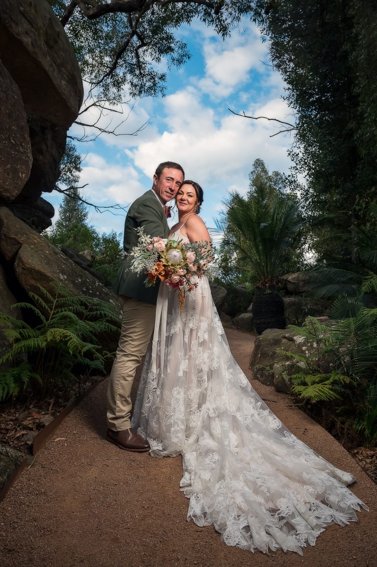 Couple with lush bouquet of natives and roses