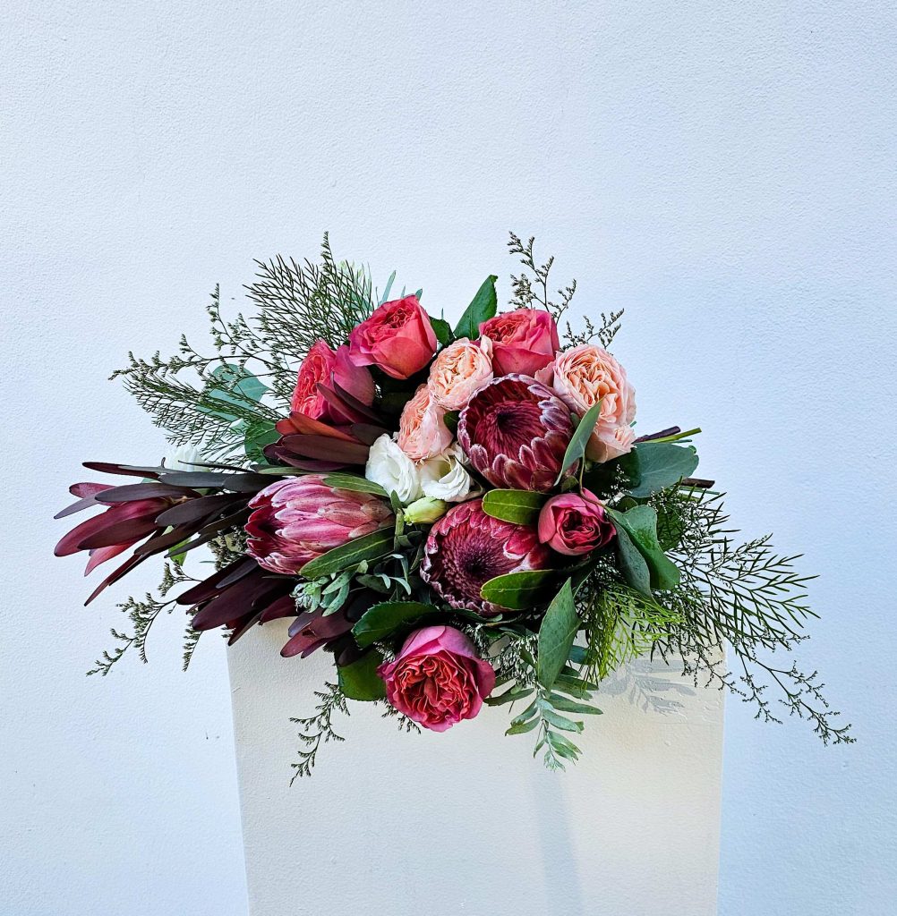 A brides bouquet of pink and green flowers